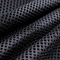 close-up of black mesh fabric texture with geometric pattern and light reflection