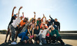 © Jacob Lund - Lively neighborhood running club celebrating together outdoors