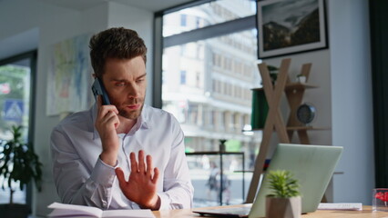 Poster - Worried ceo complaining cellphone sitting modern corporate office closeup.