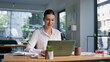 © stockbusters - Successful employee reading laptop great news on office. Confident businesswoman