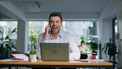 Poster - Smiling consultant talking mobile phone working at laptop workplace closeup. 