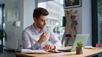 Poster - Tensed office worker looking laptop feeling overworked at workspace closeup.