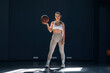 © standret - Sportive woman is with basketball ball indoors