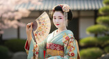 Beautiful geisha in kimono with a fan
