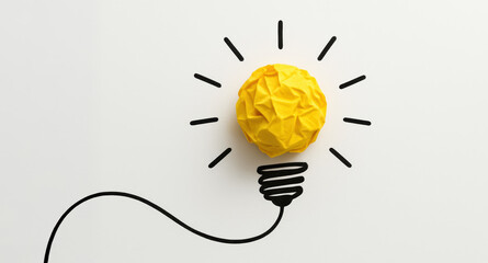 Poster - A yellow crumpled paper ball on a white surface symbolizes creative energy and innovation powering new business ideas and solutions