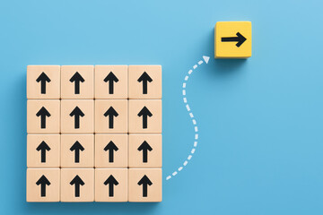 Poster - Innovation and progress are symbolized by a single block diverging from uniform direction among a group aligned blocks