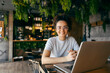 © Dusan Petkovic - Portrait of multicultural female freelancer sitting in cafe with laptop in front of her.