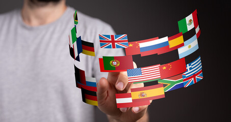 Leinwandbilder - Image of a person interacting with a digital display of various national flags, representing global communication and international relations.