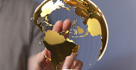 Leinwandbilder - Abstract image of a hand interacting with a golden globe, symbolizing global connectivity and networking.
