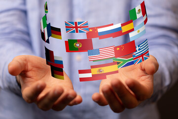 Leinwandbilder - Image of hands gently holding various national flags, symbolizing international collaboration and global business.