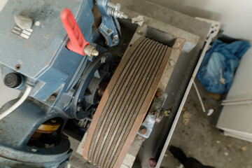Poster - Detailed view of an industrial elevator's cable pulley system.  Shows wear and tear.