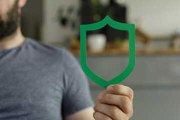 Aufkleber - Image of a man holding a green shield, representing safety, security, and protection.