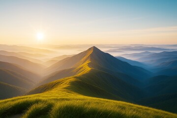 Poster - Majestic mountain landscape with golden sunrise light casting over grassy ridge and misty valleys, symbolizing nature's peaceful awakening concept.