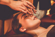 © InfiniteFlow - Caucasian woman enjoying relaxing anti-stress head massage and pampering facial beauty skin recreation leisure in warm candle lighting ambient salon spa in luxury resort or hotel. Quiescent