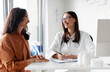 © Home-stock - Friendly woman doctor therapist and female patient sitting and talking, looking at each other in medical clinic office during consultation