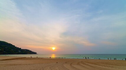 Wall Mural - time lapse scenery sunset above the ocean clouds cover the ocean during colorful 

cloud in sunset on Karon beach Phuket Thailand. 

video 4K. Scene of sweet yellow light in the sky background.