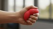 © Miracle - Hand squeezing red stress ball