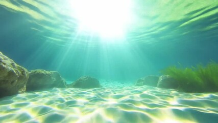Poster - Underwater Paradise: Sunbeams pierce through the crystalline water, illuminating a tranquil underwater world. Sandy seabed.