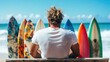 © Pinklife - A pensive surfer sitting on a bench, surrounded by colorful surfboards, gazing at the ocean waves, evoking thoughts of adventure and nature's beauty.