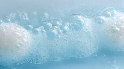 Poster - Delicate soap bubbles floating on light blue water, forming iridescent foam and revealing soft textures of cleanliness and serenity