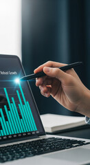 Poster - Close-up of hand using stylus on laptop screen displaying upward trending bar graph, showcasing business growth and success