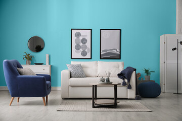 Poster - Stylish living room with comfortable sofa and light blue wall. Interior design