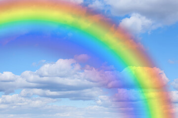 Wall Mural - bright rainbow in blue sky with clouds on sunny day