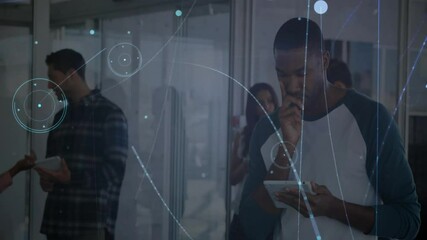 Poster - Woman gesturing while man using tablet discussing notebook as circles drifting forming data overlay