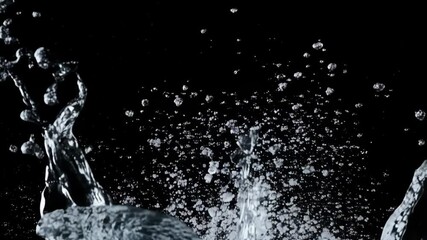 Poster - Abstract water splash in action with clear drops rising against black background, representing liquid movement and purity