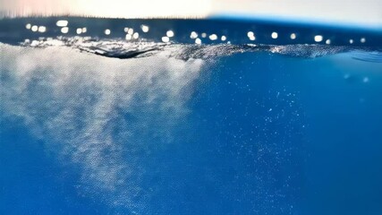 Poster - Blue water surface with ripples and bubbles in the clear liquid, underwater view of refreshing turquoise water