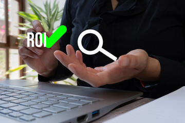 Poster - Person holding up hand with magnifying glass over the word 