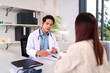 © snowing12 - Medical Consultation: A doctor in a bright clinic discusses medication with a patient, illustrating healthcare support.