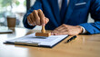 © Riski Digital Studio - Businessman Approving Documents with Wooden Stamp