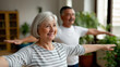 © Curioso.Photography - Senior couple practicing stretching or yoga at home for physical fitness and wellbeing.