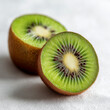 © miyuta - Product photo of kiwi fruit, kiwi cut in half with seeds clearly visible forming a symmetrical pattern, matte white surface provides soft contrast, ai generated images.