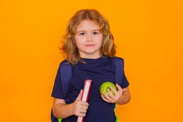 Fototapete - Smart child, clever school kid. School child with book isolated on yellow background. Elementary school. Pupil go study. Clever schoolboy learning. Kids study, knowledge and education concept.