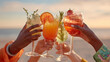 © dinatychynska - Hands toasting with colorful cocktails on beach at sunset. Celebration, tropical vibes, summer vacation, refreshing drinks, friendship, joyful travel moment in warm evening light.