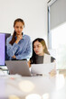 © David - Two business woman lawyer or company employee holding accounting bookkeeping documents checking financial data or marketing report working in office with laptop. Paperwork management