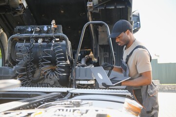 Aufkleber - Truck repair service. African american Mechanic makes computer diagnostic of the semitruck