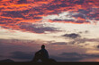 © Cavan Images - Silhouette of a person celebrating at sunset