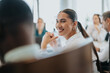 © qunica.com - A cheerful businesswoman smiles during a multicultural office meeting, showcasing teamwork and collaboration.