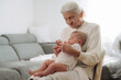 © standret - Holding toddler in hands. Grandmother with cute toddler baby at home
