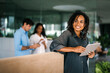 © NDABCREATIVITY - Successful happy african american business woman, startup coworker or software programmer engineer