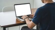 © YUSUF - Person Working on Laptop with Blank Screen Mockup Perfect for Website or App Presentation