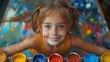 © Pinklife - A joyful girl covered in paint splatters smiles brightly while surrounded by colorful art supplies, encapsulating the essence of childhood creativity and the joy of artistic expression.