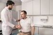 © illustrissima - Doctor examining male patient with shoulder pain during physical assessment in clinic, concept of musculoskeletal disorder, orthopedic diagnosis, injury treatment, physical therapy and rehabilitation