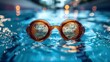 © Pinklife - A pair of orange swimming goggles floating on the serene surface of a pool, creating an inviting atmosphere highlighted by beautiful reflections and bokeh lights.