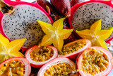 Colorful display of tropical fruits including dragon fruit, passion fruit, and star fruit