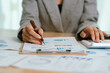 © Kieng - Businessman analyzing financial charts and documents at office desk, focused on planning, investment, accounting, growth strategy, and corporate success