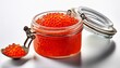 © Arnold - bright red caviar displayed in glass jar with spoon on white background